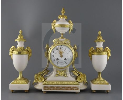 A Louis XVI style ormolu mounted white marble clock garniture, decorated with goat's head motifs, the mantel clock with flora
