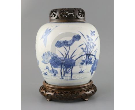 A Chinese blue and white ovoid jar, Kangxi period, painted with egrets amid a lotus pond, double circle mark to base, H. 20.5