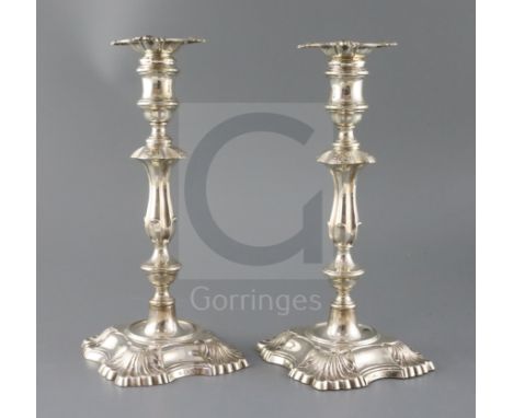 A pair of late Victorian silver candlesticks by William Hutton &amp; Sons Ltd, with waisted knopped stems, on fluted square b