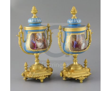 A pair of 19th century French ormolu mounted Sevres style porcelain urns, with jewelled decoration, painted with scenes of no