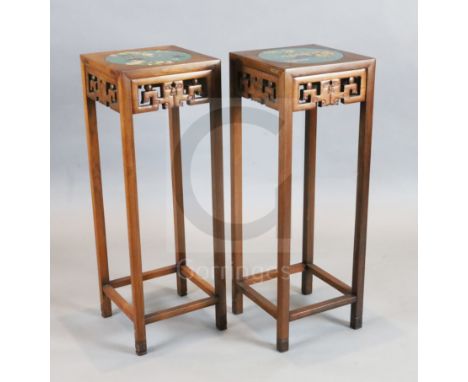 A pair of Chinese hardwood vase stands, each inset with cloisonne panels depicting birds on a branch and flowers in a jardini