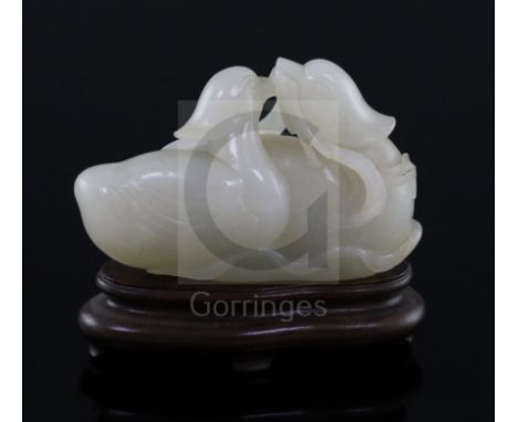 A good Chinese white jade group of two mandarin ducks biting lotus tendrils, 18th/19th century, the stone of even tone with s