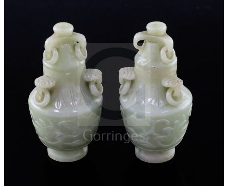 A pair of Chinese carved jade vases and covers, with ring handles and decorated with foliate motifs, height 12cmCONDITION: Bo