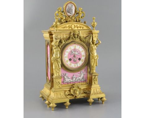 A late 19th century French ormolu and Sevres style porcelain mantel clock, of architectural form, surmounted with cherubs hol