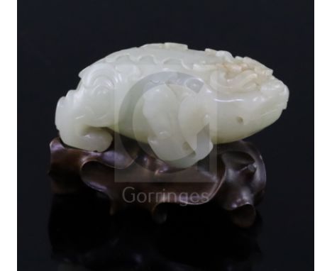 A Chinese pale celadon jade figure of lion-dog, bixi, 17th century, the stone of even tone with natural inclusions, L. 6.8cm,