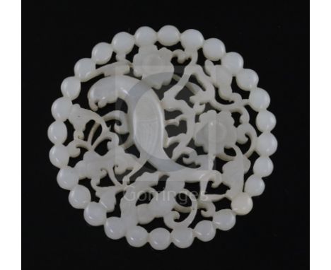 A fine Chinese white jade disc, 18th/19th century, reticulated and carved with a bird amid prunus and lingzhi sprigs, D. 5.7c