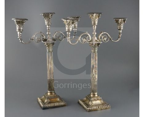 A pair of late Victorian silver corinthian column two branch, three light candelabra by Walker &amp; Hall,(a.f.) with scroll 