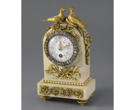 An early 20th century French ormolu mounted white marble desk timepiece, surmounted with two lovebirds above a paste bezelled