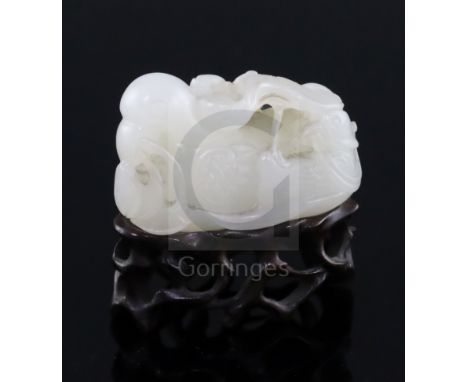 A Chinese white jade group of mandarin ducks, 19th/20th century, each biting lotus tendrils, the stone of good even tone, L. 