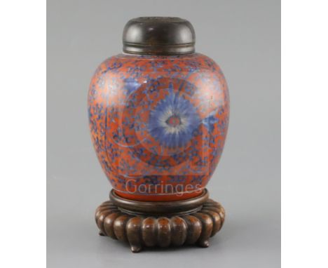 A Chinese coral red ground underglaze blue jar, Kangxi period, painted with flowerheads and scrolling tendrils, H. 12.3cm, ex