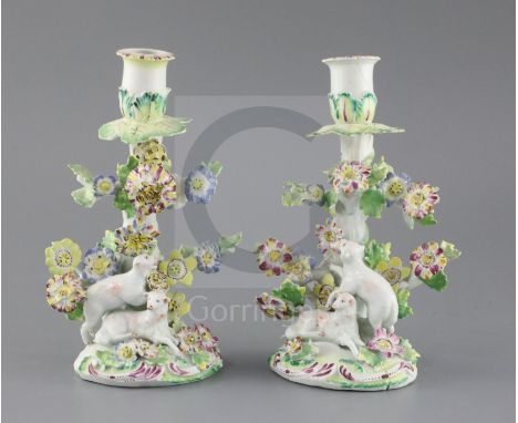 A pair of early Derby 'sheep' candlesticks, c.1758, each modelled with two sheep below a flower encrusted tree, patch marks, 