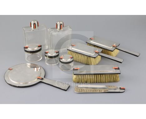 A George V Cartier Ltd Art Deco ten piece silver, coral and black enamel mounted dressing table set, comprising a hand mirror