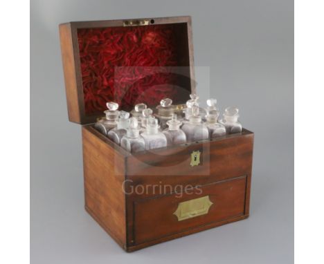 A Victorian brass inset mahogany apothecary's casket, the rising lid opening to reveal fifteen glass vessels, the base drawer
