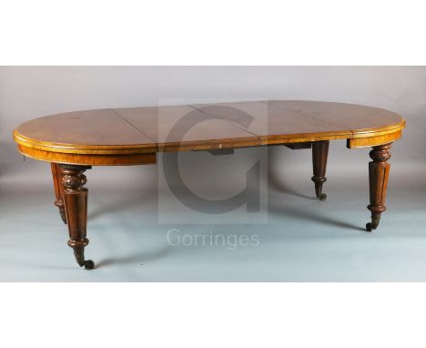 A Victorian figure and burr walnut extending dining table, with demi lune ends and carved turned and fluted tapered legs, fit