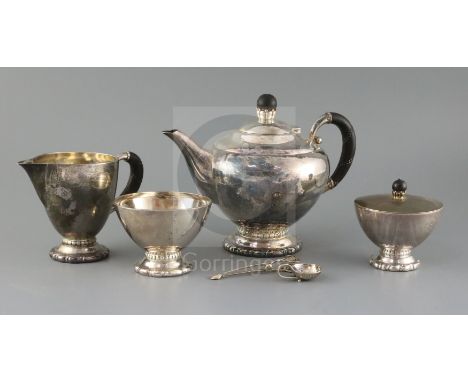 A 1920's Danish Georg Jensen matched sterling silver four piece tea set, together with a caddy spoon and pair of sugar tongs,