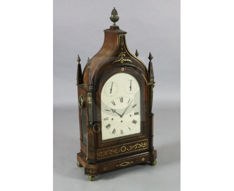 A large Regency brass inset mahogany repeating chiming bracket clock, with swept arched case, flanked by Egyptianesque pilast