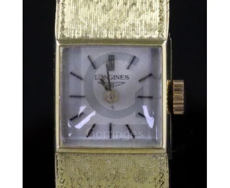 A lady's 18ct gold Longines manual wind wrist watch, with square dial and baton numerals, on integral 18ct gold bracelet.COND