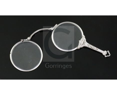 A 1920's style platinum? and diamond set lorgnette, with engraved borders and diamond encrusted pierced handle.CONDITION: Doe