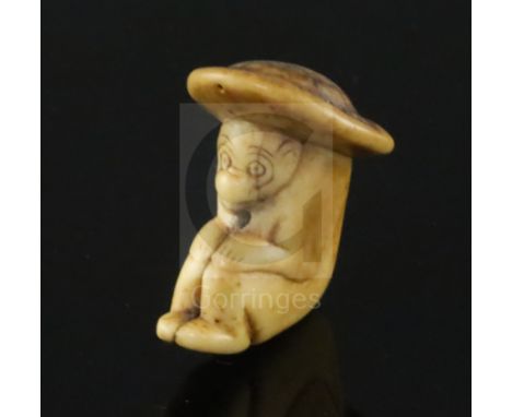 An 18th century Japanese stag horn netsuke of a monkey wearing a broad rimmed hat, depth 4cm height 4.75cmCONDITION: A hairli