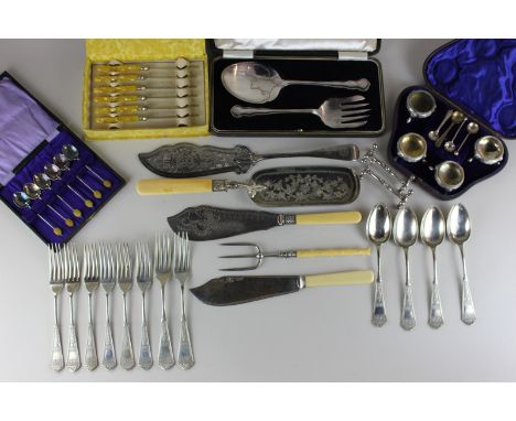 An assortment of silver plated flatware to include servers, crumb scoops, butter knives (some cased), knife rests and salts