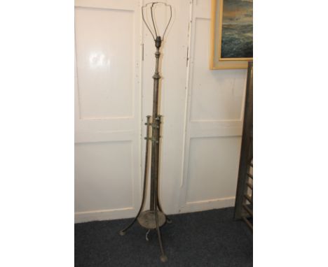 An adjustable metal standard lamp with central column on circular base, supported by three curved supports (NC)