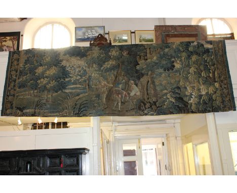 A large 19th century tapestry depicting a figure in a wood, 400cm by 300cm approx. (NC)