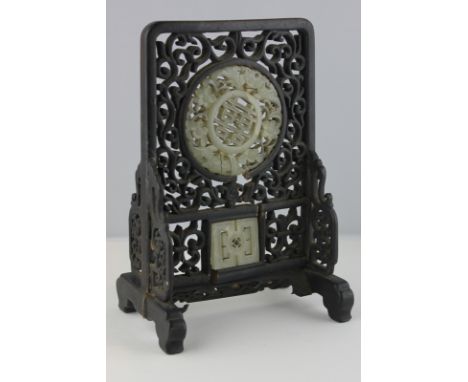 A Chinese jade mounted rosewood table screen circular jade plaque with pierced decoration (parts missing), 22cm high (NC)