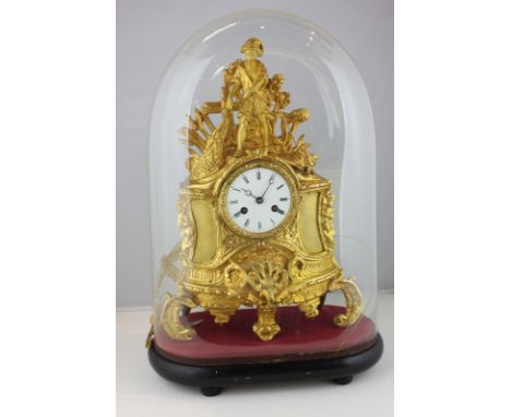 A French brass ormolu mantel clock surmounted with a figure of a fisherman hauling in a net, with white enamel dial and movem