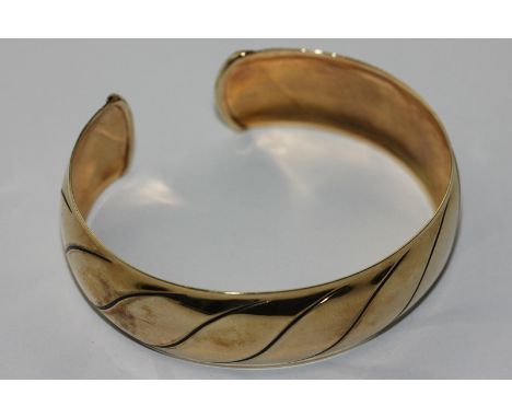 A 9ct gold open end bangle, 14g