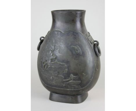 A Japanese bronze vase with two ring handles, cast with a scene of buildings, trees and crescent moon, 30cm high, (NC)