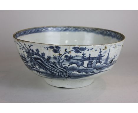 A blue and white porcelain bowl, possibly Worcester, decorated with a Chinese landscape, riveted repairs (a/f), 22cm, (NC)