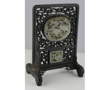 A Chinese jade mounted rosewood table screen with pierced decoration (parts missing), 22cm high (NC)