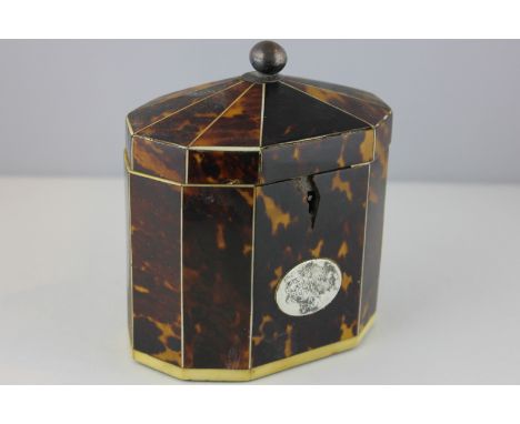 A George III tortoiseshell tea caddy, faceted oval form with domed cover (a/f), 13cm