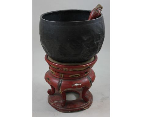 A Japanese bronze drum, bowl shape on red lacquered circular stand, overall 59cm high, (NC)