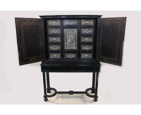 An early 19th century Italian ebonised cabinet on stand with an arrangement of drawers and cupboard with bone inlaid decorate