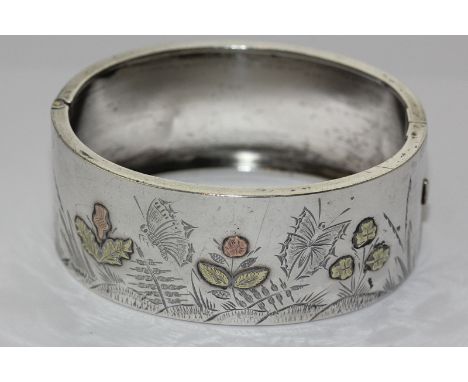 A silver and two colour gold overlaid bangle