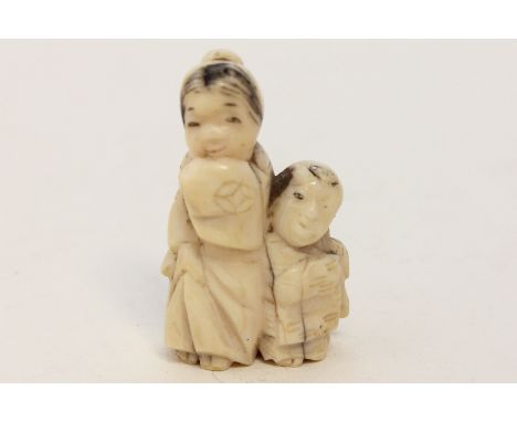 A 19th century carved ivory netsuke of two children, 4cm high