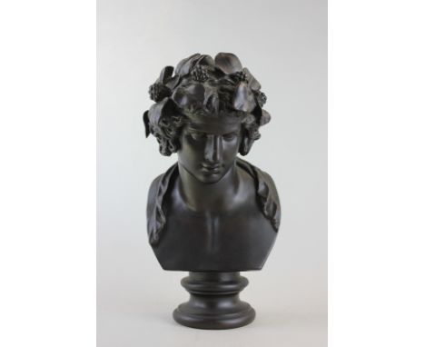 A 20th century bronze bust of 'Dionysus' (god of wine), with fruit and leaves in his hair on circular base, 30cm high