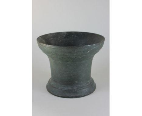 A bronze mortar with flared rim and circular base, 16.5cm high, (NC)