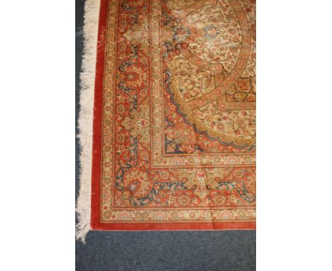 An Iranian Qum hand-knotted silk carpet in pink, blue and cream all-over floral pattern, with large central floral motif, ori