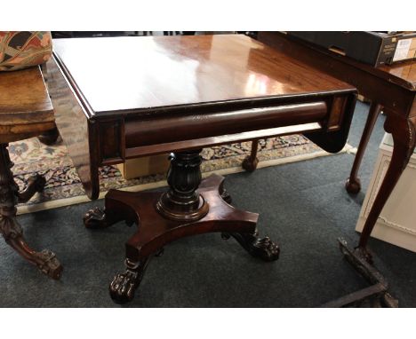 A William IV mahogany sofa table with shaped drawer on turned leaf pillar support, quatrefoil base with scroll feet, 127cm ex