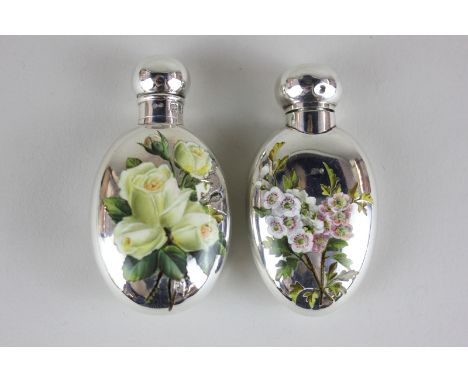Two Victorian silver and enamel oval scent bottles, one monogrammed and enamelled with roses, the other with summer flowers, 