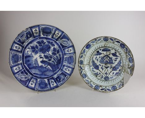 A delftware blue and white pottery charger decorated with peacock centre and panelled border (a/f), 36cm, and another shallow