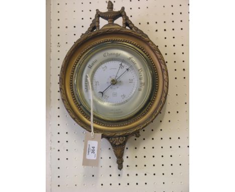 An aneroid barometer, circular, moulded gilt frame in neo-classical style, 14in. high 