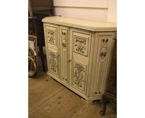 A cream gesso side cupboard, single shelf enclosed by a pair of panelled doors with painted flower panels, 3ft. 7in. - one re