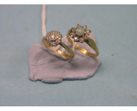 Two 18ct. gold and diamond cluster rings, one ring with central opal, latter size N