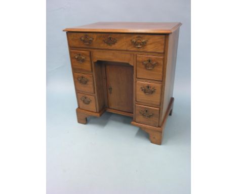 A Chippendale-period mahogany kneehole desk, single long drawer and six short drawers, sliding tray above kneehole cupboard, 