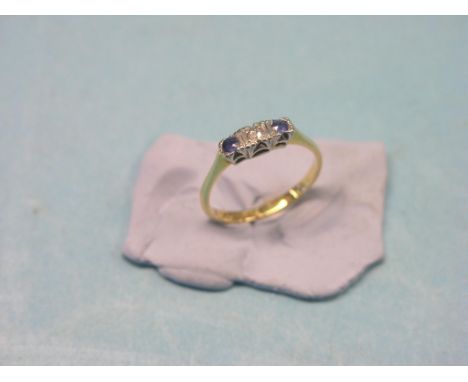 An 18ct. gold half-hoop ring, set central diamond and two sapphires, size L/M