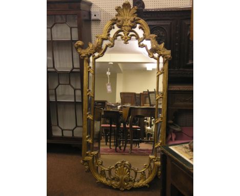 A large rococo-style gilt-framed mirror, arched-shape with plume cresting and leaf-scrolls, 4ft. 6in. high 