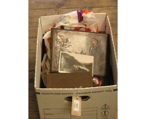 A large collection of postcards, many early 20th century, and a Victorian family portrait photograph album, with contents